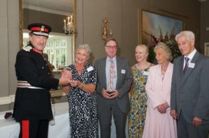 Long serving volunteers accept the Queen's Award from the Lord Lieutenant